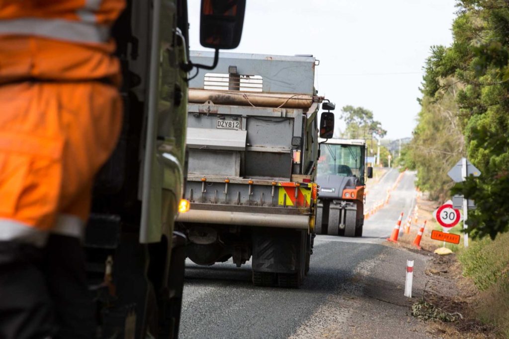 Road construction vehicles and workers during a road maintenance project