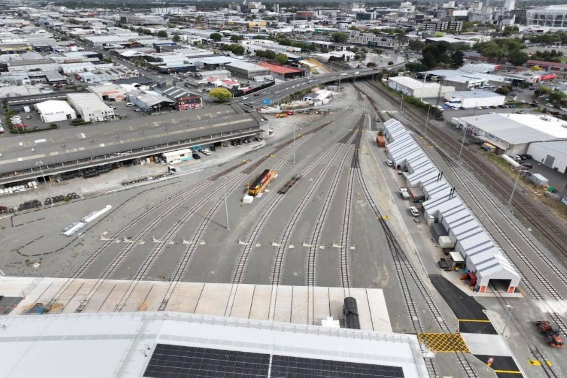 Aerial view of a large railway yard with multiple train tracks and maintenance buildings